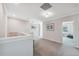 Hallway area with neutral carpeting, leading to bedrooms and ample lighting at 727 Key Royale Dr, Holmes Beach, FL 34217