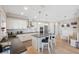 Bright kitchen boasts white cabinetry, a center island with barstools, and modern lighting at 727 Key Royale Dr, Holmes Beach, FL 34217
