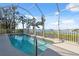 Sparkling screened-in pool surrounded by tropical landscaping, offering a private oasis at 727 Key Royale Dr, Holmes Beach, FL 34217