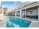 Back of house and swimming pool, with screened porch and covered patio area at 727 Key Royale Dr, Holmes Beach, FL 34217