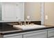 Bathroom vanity showcasing dark granite counters, sink, and custom cabinets at 727 Key Royale Dr, Holmes Beach, FL 34217