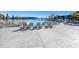 Resort-style community pool with lounge chairs and umbrellas provides the perfect relaxing retreat at 7673 Yale Harbor Dr, Wesley Chapel, FL 33545