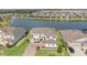 Stunning aerial view of a lakeside community featuring well-maintained lawns and beautiful homes at 7721 Roma Dune Dr, Wesley Chapel, FL 33545