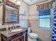 Bathroom features vanity with granite countertop, tile floor, and blue and white accents at 8208 Rhanbuoy Rd, Spring Hill, FL 34606