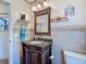 Cozy bathroom featuring a granite countertop vanity and decorative accents for a comfortable home at 8208 Rhanbuoy Rd, Spring Hill, FL 34606