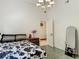 Bright bedroom featuring a cow print bed set, stylish chandelier, and an open doorway at 8208 Rhanbuoy Rd, Spring Hill, FL 34606
