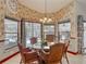 Bright dining room with a glass table, wicker chairs, and views of the pool area at 8208 Rhanbuoy Rd, Spring Hill, FL 34606