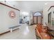 Spacious entryway featuring tile floors, seating, a stylish front door, and bar seating area at 8208 Rhanbuoy Rd, Spring Hill, FL 34606