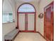 Grand foyer featuring a decorative glass window over the front door at 8208 Rhanbuoy Rd, Spring Hill, FL 34606