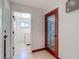 Hallway leading to laundry room with tile flooring, decorative door and fresh paint at 8208 Rhanbuoy Rd, Spring Hill, FL 34606