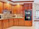 Elegant kitchen featuring granite countertops, custom wood cabinetry, and stainless steel appliances at 8208 Rhanbuoy Rd, Spring Hill, FL 34606