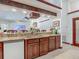Open concept kitchen boasts custom wood cabinetry, granite countertops, and a breakfast bar area at 8208 Rhanbuoy Rd, Spring Hill, FL 34606