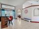 Open floor plan with a wet bar and arched doorway, perfect for entertaining at 8208 Rhanbuoy Rd, Spring Hill, FL 34606