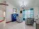 Bright living room with tile flooring, matching blue decor, and a large window for natural light at 8208 Rhanbuoy Rd, Spring Hill, FL 34606