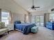 Spacious main bedroom with a luxurious upholstered headboard and sliding glass doors to the pool at 8208 Rhanbuoy Rd, Spring Hill, FL 34606