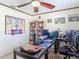 Well-lit office space with multiple computer monitors, built-in bookshelves, and neutral decor at 8208 Rhanbuoy Rd, Spring Hill, FL 34606