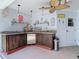 The outdoor kitchen with a grill and sink offers a convenient space for entertaining at 8208 Rhanbuoy Rd, Spring Hill, FL 34606