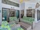 Relaxing screened patio with wicker furniture and tropical decor creates a comfortable space at 8208 Rhanbuoy Rd, Spring Hill, FL 34606