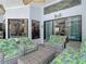 A screened patio with wicker furniture and tropical décor provides relaxation at 8208 Rhanbuoy Rd, Spring Hill, FL 34606