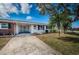 Inviting single-story home showcases a well-kept front yard and charming blue shutters at 10022 Lily N St # N, Pinellas Park, FL 33782