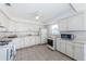 Bright kitchen featuring white appliances, ample cabinet space, and neutral tile flooring for a clean, classic look at 10022 Lily N St # N, Pinellas Park, FL 33782