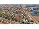 Expansive aerial view of a suburban neighborhood with lake views, mature trees, and proximity to highway at 18605 Le Dauphine Pl, Lutz, FL 33558