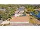 Aerial shot of homes showing roofs, pools, and yards with lake in the background at 18605 Le Dauphine Pl, Lutz, FL 33558