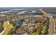Distant aerial shows community with lakes, golf course and highway in the background at 18605 Le Dauphine Pl, Lutz, FL 33558
