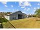 Backyard featuring a long lawn with a pool in an enclosed patio at 18605 Le Dauphine Pl, Lutz, FL 33558