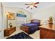 Bedroom with a queen size bed, ceiling fan, and a large arched window at 18605 Le Dauphine Pl, Lutz, FL 33558