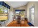 Bright dining area with large windows overlooking the lake at 18605 Le Dauphine Pl, Lutz, FL 33558