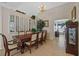 Elegant dining room featuring a large table with seating for six and lots of sunlight at 18605 Le Dauphine Pl, Lutz, FL 33558
