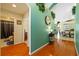Hallway with wood floors providing views of the bathroom and kitchen area at 18605 Le Dauphine Pl, Lutz, FL 33558