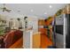 Open kitchen with stainless appliances and breakfast bar seamlessly connecting to the living room at 18605 Le Dauphine Pl, Lutz, FL 33558
