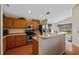 Well-equipped kitchen with stainless steel appliances, wood cabinets, and breakfast bar at 18605 Le Dauphine Pl, Lutz, FL 33558