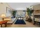 Cozy living room with sofa, chairs, plants and bright natural light at 18605 Le Dauphine Pl, Lutz, FL 33558
