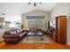 Bright living room boasts hardwood floors, a large window, and ample seating with nice decor at 18605 Le Dauphine Pl, Lutz, FL 33558