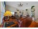 Inviting living room features vaulted ceilings, wood floors, and a comfortable leather sofa at 18605 Le Dauphine Pl, Lutz, FL 33558