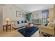 Inviting living room with comfortable seating, accent pillows and a beautiful area rug at 18605 Le Dauphine Pl, Lutz, FL 33558
