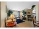 Cozy living room with sofa, chairs, plants and bright natural light at 18605 Le Dauphine Pl, Lutz, FL 33558