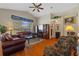 Spacious living room with comfortable seating, ceiling fan, and bright natural light at 18605 Le Dauphine Pl, Lutz, FL 33558