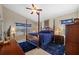 Relaxing main bedroom with 4-post bed, ensuite bath and dual windows at 18605 Le Dauphine Pl, Lutz, FL 33558