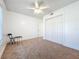The bedroom offers neutral carpeting, a ceiling fan, and a closet with sliding doors at 19109 Sunlake Blvd, Lutz, FL 33558