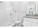 Clean bathroom with walk in shower, gray countertop vanity and modern lighting at 242 Estado Ne Way, St Petersburg, FL 33704