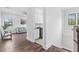 Bright hallway with hardwood floors leading to the laundry room and living area at 242 Estado Ne Way, St Petersburg, FL 33704