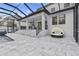 A spacious patio with marble steps offers an outdoor kitchen, lounge area, and covered seating beneath the home's facade at 242 Estado Ne Way, St Petersburg, FL 33704
