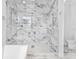 Stunning marble shower with glass doors and modern fixtures in luxurious bathroom at 242 Estado Ne Way, St Petersburg, FL 33704