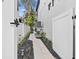 A manicured side yard with a stone pathway, decorative mulch, and privacy fencing enhances the property's curb appeal at 242 Estado Ne Way, St Petersburg, FL 33704