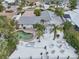 Outdoor living space with a pool, deck, and tropical landscaping, perfect for entertaining and relaxation at 6446 Lake Sunrise Dr, Apollo Beach, FL 33572