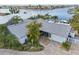 Waterfront home with a well-maintained yard, brick driveway, and serene canal access at 6446 Lake Sunrise Dr, Apollo Beach, FL 33572